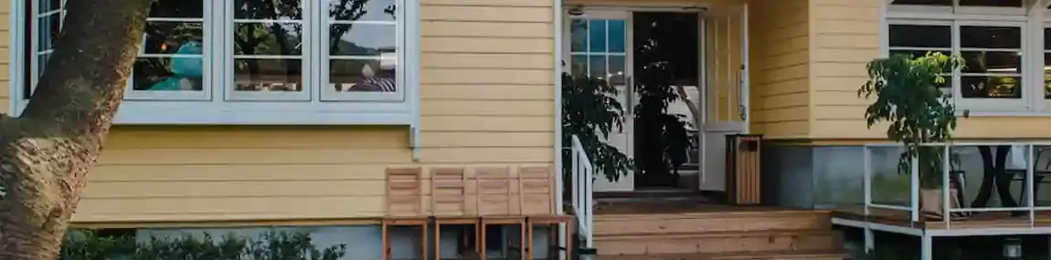 Woman walking into a luxury home with a dog