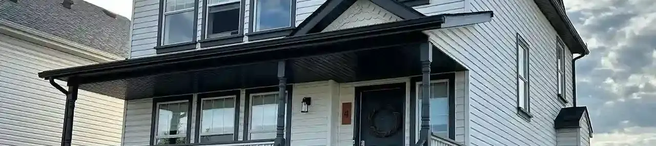 Woman walking into a luxury home with a dog
